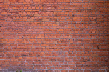 A fragment of a red brick wall at an idle factory,shot in late autumn