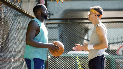 Trainer and basketball player talking about future game, active lifestyle