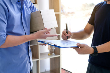 Man receiving package and signing.