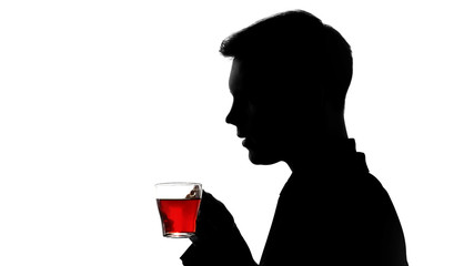 Male shadow enjoying aroma of freshly brewed tea, rest after work day, quality