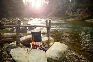 Cooking food in pot over campfire outdoor