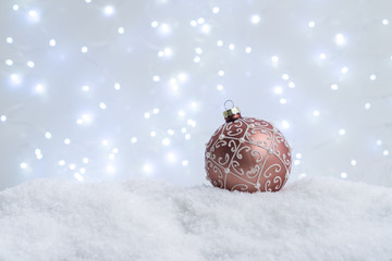 White christmas with snow - pink ball in snow close up
