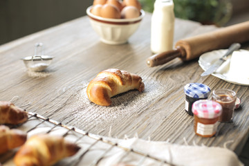 Hand made croissant and ingredients to make it on a wooden table