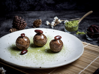 Healthy organic date energy balls with green tea, red bean, dried fruits and nuts. Food for healthy lifestyle.