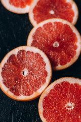 Delicious  fresh cut of raw grapefruit on dark background.  Healthy eating, dieting.