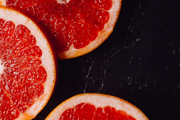 Delicious  fresh cut of raw grapefruit on dark background.  Healthy eating, dieting.