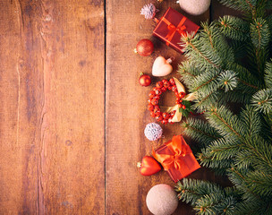 Christmas background. A lot of red vintage baubles, gift box and fir tree