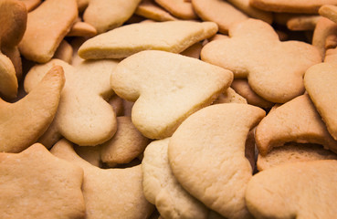 Fototapeta na wymiar Tasty homemade cookies of different shapes - heart, moon, star, flower, rhombus - baked for Christmas. Christmas background.