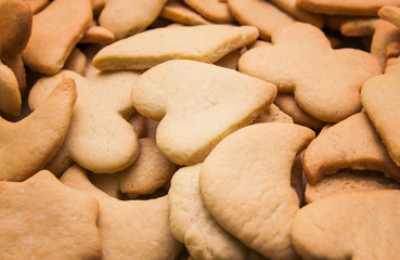 Tasty homemade cookies of different shapes - heart, moon, star, flower, rhombus - baked for Christmas. Christmas background.