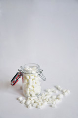marshmallow in a glass jar on white background