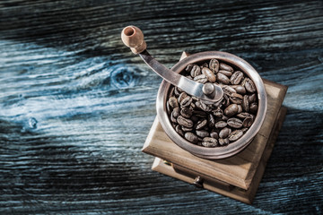 Coffee mill grains on wooden board