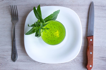 Fruit diet, cocktail with chia seeds. A fork and knife on a wooden background. Fast.