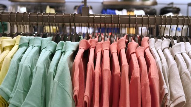 Colorful Polo T-Shirts Displayed On Hangers At Clothing Store. Close-Up.