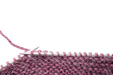Knitting needles and knitted wool fabric isolated on white background. Work in progress