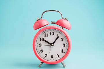 Red alarm clock on blue background