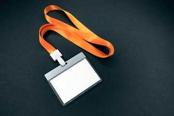 White empty staff identity mockup with orange lanyard. Name tag, ID card. Black background