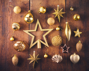 Christmas background. Set with a lot of different gold vintage baubles and stars over dark wooden board.