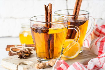 Autumn hot tea with lemon honey and spices