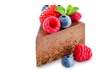 Chocolate cheesecake with fresh berries and mint leaves isolated