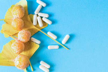 Natural pills for brain. Extract Ginkgo biloba. Blue background.