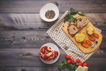 A large piece of baked meat Still life on a light wooden table.