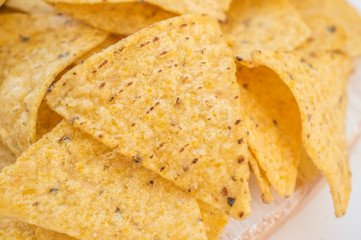 Background of corn tortillas or Nachos fried on open fire. Copy space. Close up