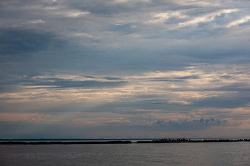 sea beach skyline with clouds and calm water