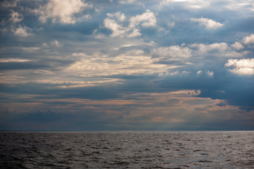 Fototapeta premium sea beach skyline with clouds and calm water