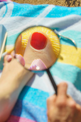 Woman magnifying pedicure