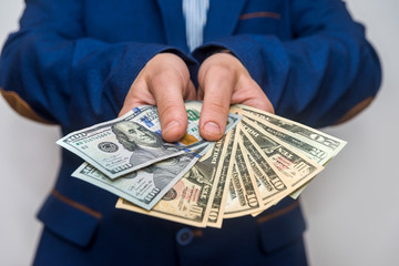 Male hands showing dollar banknotes close up