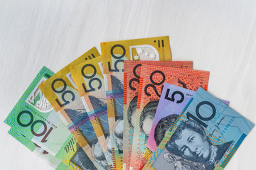 Australian dollars in fan on wooden table, closeup