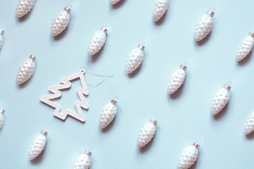 Christmas white cone and herringbone-tree decoration on pastel blue. Minimal flat lay and composition. Isometric pattern.