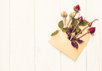 Festive bouquet of pink buds on the background of old white wooden boards