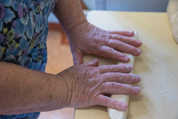 Senior lady working with dough