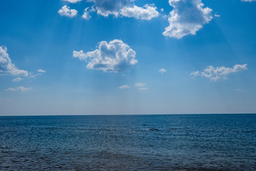 Fototapeta premium sea beach skyline with clouds and calm water