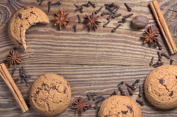 Background with oatmeal cookies and various winter spices
