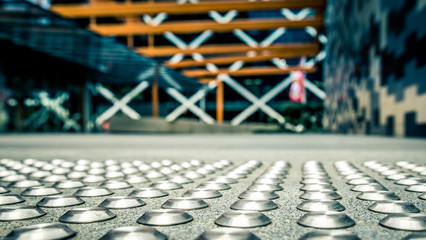Close up of metal tactiles. Modern urban setting. City district.