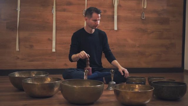 Man operating with Tibetan singing bowls