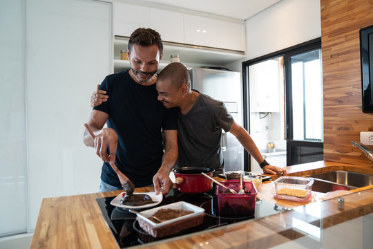 Gay Couple Embracing in the Kitchen