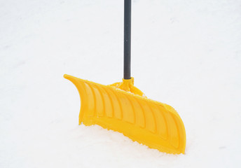 close up on snow shovel in the snow