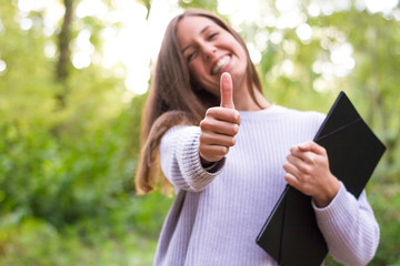 Female or young Caucasian european college girl or student with folder in college after doing final...
