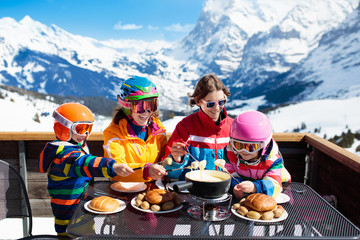Family apres ski lunch in mountains. Skiing fun.