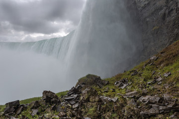 Water flowing over cliff with spray