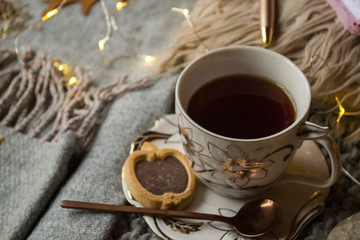 A cup of tea and decor on the table. Hygge style. Winter still life.
