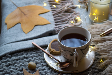 A cup of tea and decor on the table. Hygge style. Winter still life.