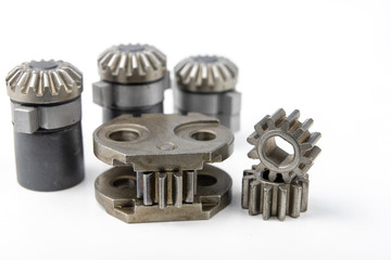 Wheels for mechanical gears on a white workshop table. Mechanical parts for mechanical devices.