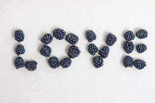 Word love made from freshly harvested blackberries