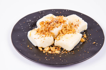 Dumplings with cottage cheese (traditional polish dish called lazy pierogi/ leniwe pierogi) fried with bread crumbs and sprinkled with sugar