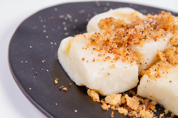 Dumplings with cottage cheese (traditional polish dish called lazy pierogi/ leniwe pierogi) fried with bread crumbs and sprinkled with sugar