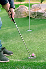 Golf ball and Golf Club on Artificial Grass.